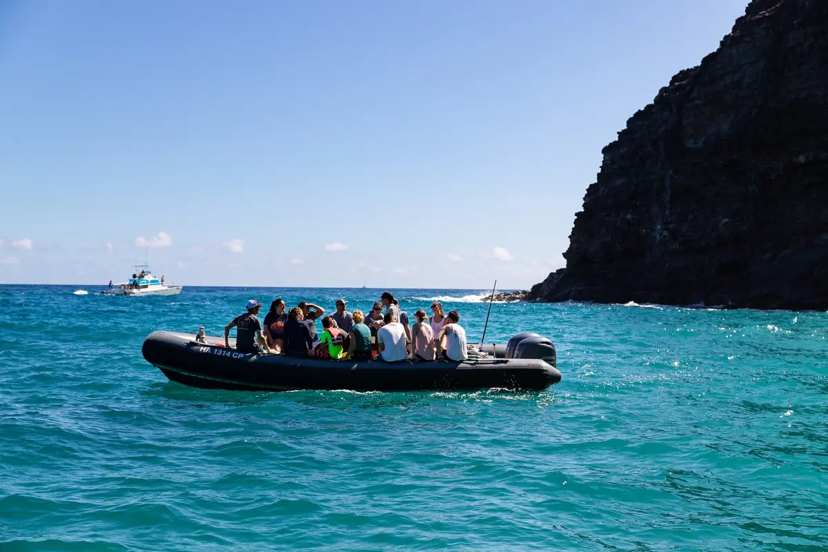 An inflatable boat below the Na Pali cliffs