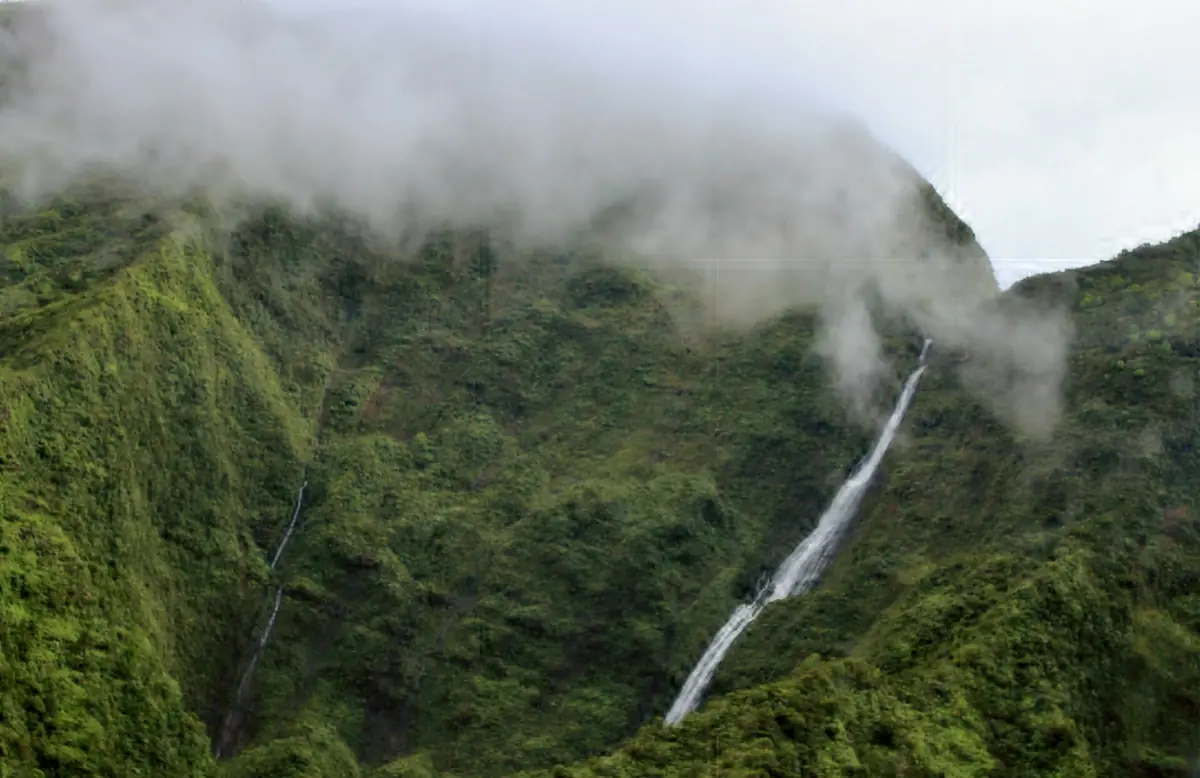 A waterfall in the clouds seen from a helicopter